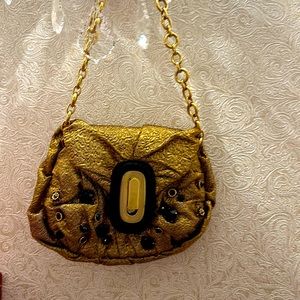 Dolce Gabbana small gold bag on a gold chain.